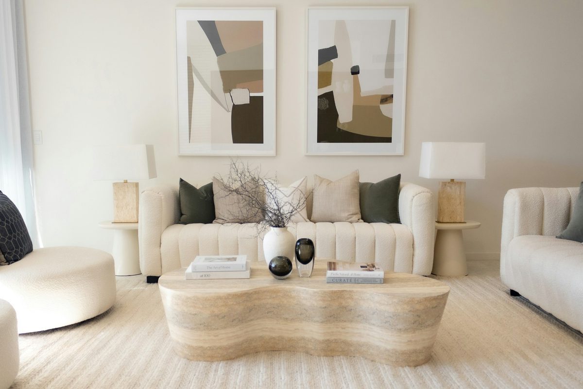 Bright, neutral living room with a boucle sofa and framed abstract art.